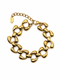 A chunky gold-tone chain link bracelet with a distinctive organic, rounded link design and an adjustable extender chain with a branded tag, shown on a plain white background.